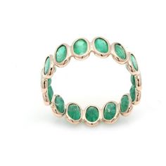 a gold ring with green stones on it