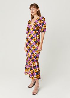 Made from sustainable, 100% crepe de chine, the Ester Dress is made to swing and sway. It’s designed with slightly puffed sleeves, a deep v-neck, and a fitted bodice with a tiered ruffle at the hem. Cast in our graphic Aquarelle print, it’s a brilliant day to night dress that you can wear from the office to a dinner date. Multicolor V-neck Midi Dress With Ruffle Hem, Retro V-neck Dress With Ruffles, Multicolor V-neck Dress With Gathered Sleeves, Fitted Multicolor Puff Sleeve Dress With Ruffles, Retro V-neck Midi Dress With Floral Print, Retro Ruffled Dresses For Brunch, Retro Ruffle Dresses For Brunch, Fitted Multicolor Midi Dress With Ruffle Hem, Retro Dresses With Ruffles For Brunch