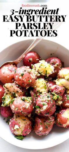 a white bowl filled with red potatoes covered in parsley