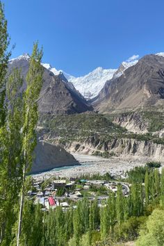 the valley is surrounded by mountains and trees