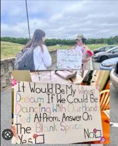 two people standing in front of a sign that says it would be my dream if we could be