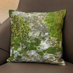 a moss covered pillow sitting on top of a brown chair