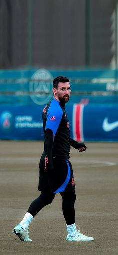 a man in black and blue running on a baseball field