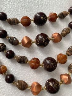 This Beaded Necklaces item is sold by ElectricEyeThrift. Ships from Peekskill, NY. Listed on Jan 26, 2024 Retro Wooden Bead Jewelry, Retro Wooden Round Bead Jewelry, Brown Multi-strand Necklace With Polished Beads, Handmade Retro Brown Necklaces, Retro Brown Handmade Necklaces, Brown Costume Jewelry Necklaces With Colorful Beads, Retro Handmade Brown Necklaces, Multi-strand Brown Jewelry With Polished Beads, Vintage Brown Jewelry With Spacer Beads