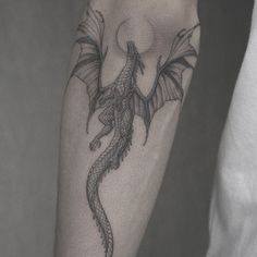 a man with a dragon tattoo on his arm