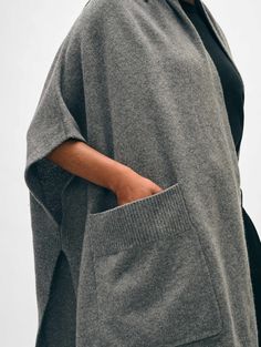 ["One of the most versatile pieces of the season, this poncho feels like a blanket, but with the fit of an oversized cardigan. The sleeves are loose and fall just over each shoulder, and the style features generous patch pockets that make for the perfect place to warm those fingers on colder days of the year. Throw on over a dress or layer on top a long-sleeve shirt or sweater. This poncho has been designed to fit to a wide range of body types, and is offered in a single size to flatter all.\n"] Open Poncho, Cashmere Travel Wrap, Dark Steel, Travel Tops, Poncho Cardigan, Blue Q, Days Of The Year, Oversized Cardigan, Cardigan Top