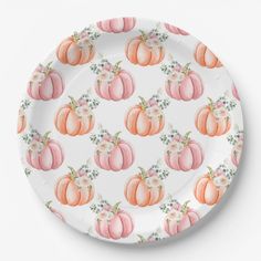 a paper plate with pink and orange pumpkins on it