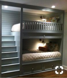 two bunk beds with ladders are shown in this room, and one bed is built into the wall