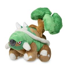 a stuffed animal with a green and white costume on it's head, sitting in front of a white background