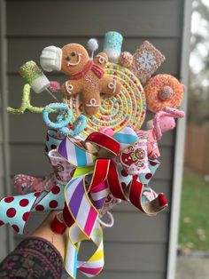 a hand holding a bunch of different colored ribbons