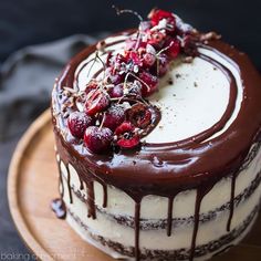 a cake with chocolate icing and cherries on top