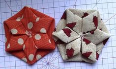 two pieces of fabric sitting on top of a cutting board