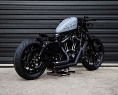 a motorcycle parked in front of a garage door