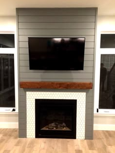 a fireplace with a flat screen tv mounted above it