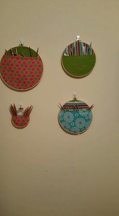 three different designs are hanging on the wall next to eachother's toothbrush holder