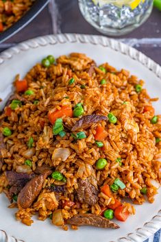 a white plate topped with rice and veggies