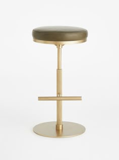 a gold stool with a black seat on a white background