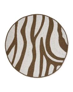 a brown and white zebra print rug on a white background with an oval design in the center