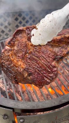 the steak is being cooked on the grill