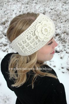 a woman wearing a white crochet headband with flowers on it in the snow