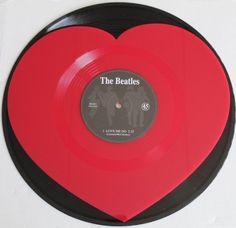 a red and black heart shaped vinyl record