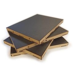 four pieces of wood are stacked on top of each other, one is black and the other is gold