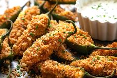 fried green peppers on a plate with dipping sauce