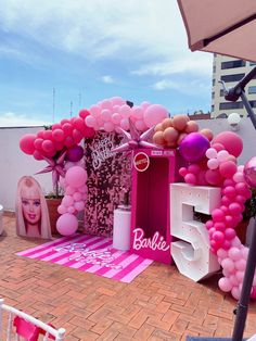 a barbie themed birthday party with balloons and decorations