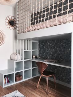 a room that has some shelves and a desk in it with a net on the wall