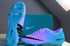 a pair of blue and purple soccer cleats next to a box with the word nike written on it