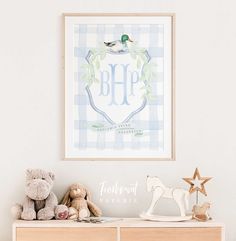 a baby's room with toys and a framed monogrammed poster on the wall