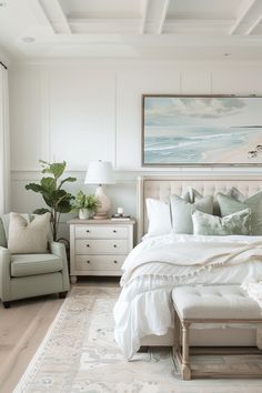 a large white bed sitting in a bedroom next to a chair