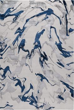 an abstract rug with blue and gray paint on the top, in front of a white background