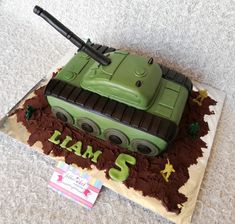 a birthday cake with a green tank on it's top and the number 5