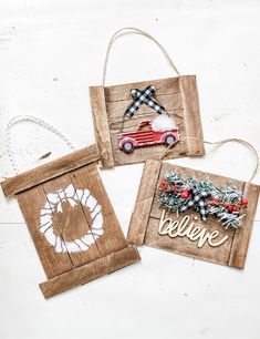 three wooden signs with christmas decorations hanging from the front and back, on a white background