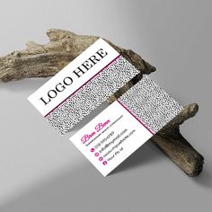 two business cards sitting on top of drift wood