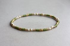 Green, Beige & Gold Bracelet  - 3mm beads - stretchy I can make the bracelet to your size.  Just send me a message or you will receive a standard size bracelet. Minimalist Handmade Green Beaded Bracelets, Earthy Green Beaded Bracelets For Everyday, Green Resizable Beaded Bracelets, Dainty Green Beaded Bracelets With Colorful Beads, Earthy Green Beaded Bracelets, Green And Brown Bracelets, Green Bracelet, Gold Arm Band, Green Beaded Bracelets