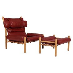 a red leather reclining chair and footstool with matching ottoman in front of a white background