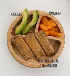 a wooden plate topped with slices of bread and sliced avocado