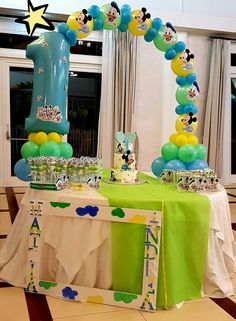 a mickey mouse themed birthday party with balloons