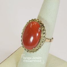 Vivid oxblood red Sardinia Coral Ring set in 14k yellow gold!Ring Size: 6.25Total Weight: 8.45 gramsPrecious Metal: 14k solid goldPrecious stones:-Coral Center Stone: 22.1mm x 15.5mm, 14.5caratsHallmark: 14k, TAIWAN Red Oval Cabochon Jewelry With Polished Finish, 14k Gold Red Cabochon Ring, 14k Gold Cabochon Red Ring, Red Ruby Oval Cabochon Ring In 14k Gold, 14k Gold Rings With Red Cabochon, Oval Cabochon Red Ruby Ring In 14k Gold, Formal Carnelian Oval Cabochon Jewelry, Red Oval Jewelry With Polished Finish, Formal Oval Cabochon Carnelian Jewelry