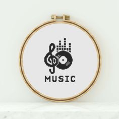 a cross stitch pattern with the word music on it and a record in the middle