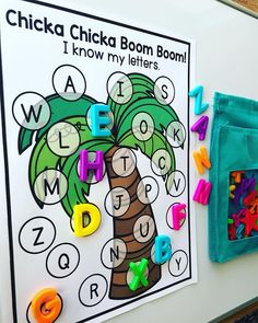 a bulletin board with letters and magnets on it that read, chicka chicka boom boom boom i know my letters