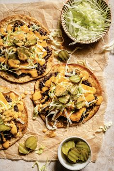 three flatbread pizzas topped with cheese, pickles and jalapenos