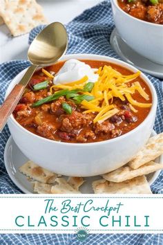 two bowls of chili with cheese and crackers