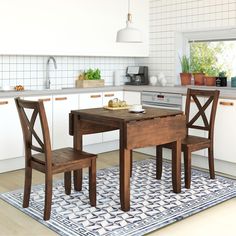 a kitchen with a table and two chairs