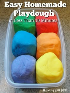 four different colored doughs in a plastic container