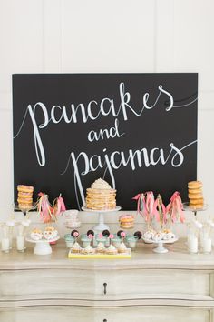 an image of a table with desserts on it and a sign that says pancakes and pajama's