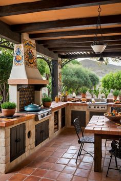 the outdoor kitchen has an oven, table and chairs