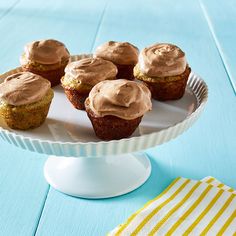 cupcakes with chocolate frosting on a cake plate